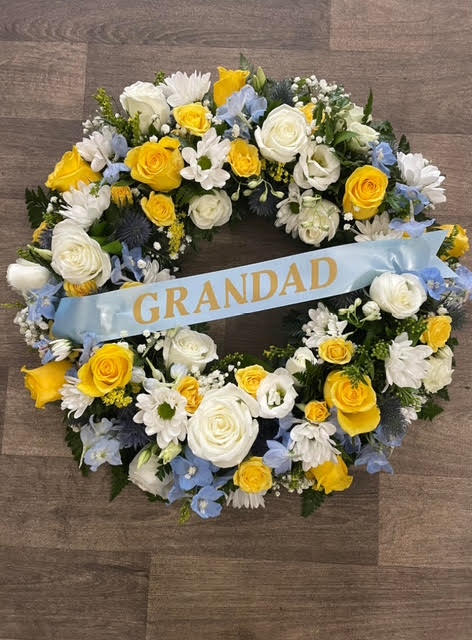 Yellow & pastel blue traditional Wreath - £85.00 approximately 16 inches round. Can be with or without the sash, wording can be changed